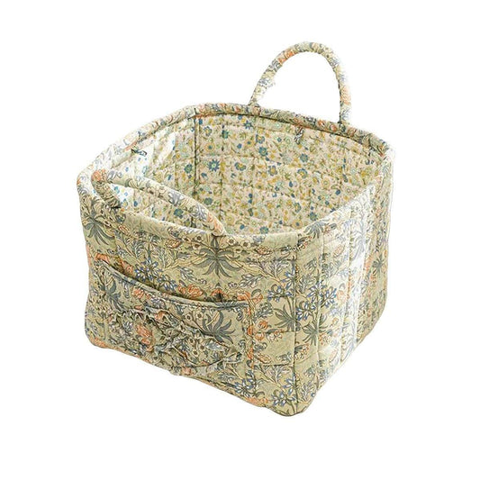 Floral fabric storage basket with stitched handle and quilted side panels, multicolor