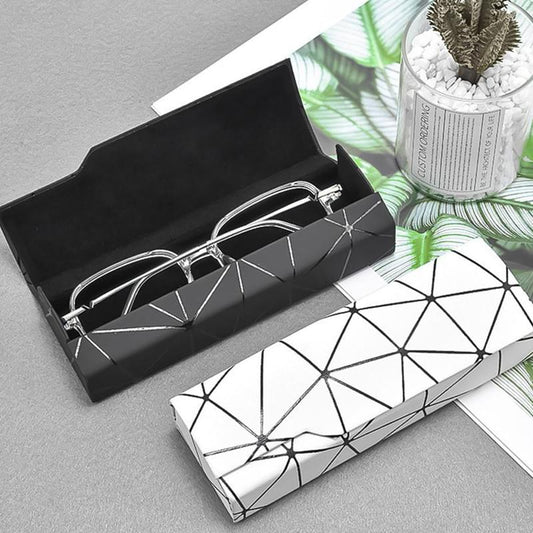 Geometric eyeglass case with black interior tray and white cover with black lines
