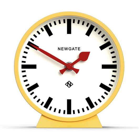 Yellow mantel clock with white face, black Roman numerals, red hands, Newgate
