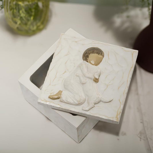Resin pet urn keepsake box with child hugging dog relief, front angled view
