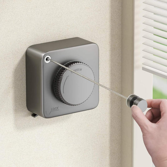 Wall-mounted retractable clothesline with gray housing and stainless steel pull rope