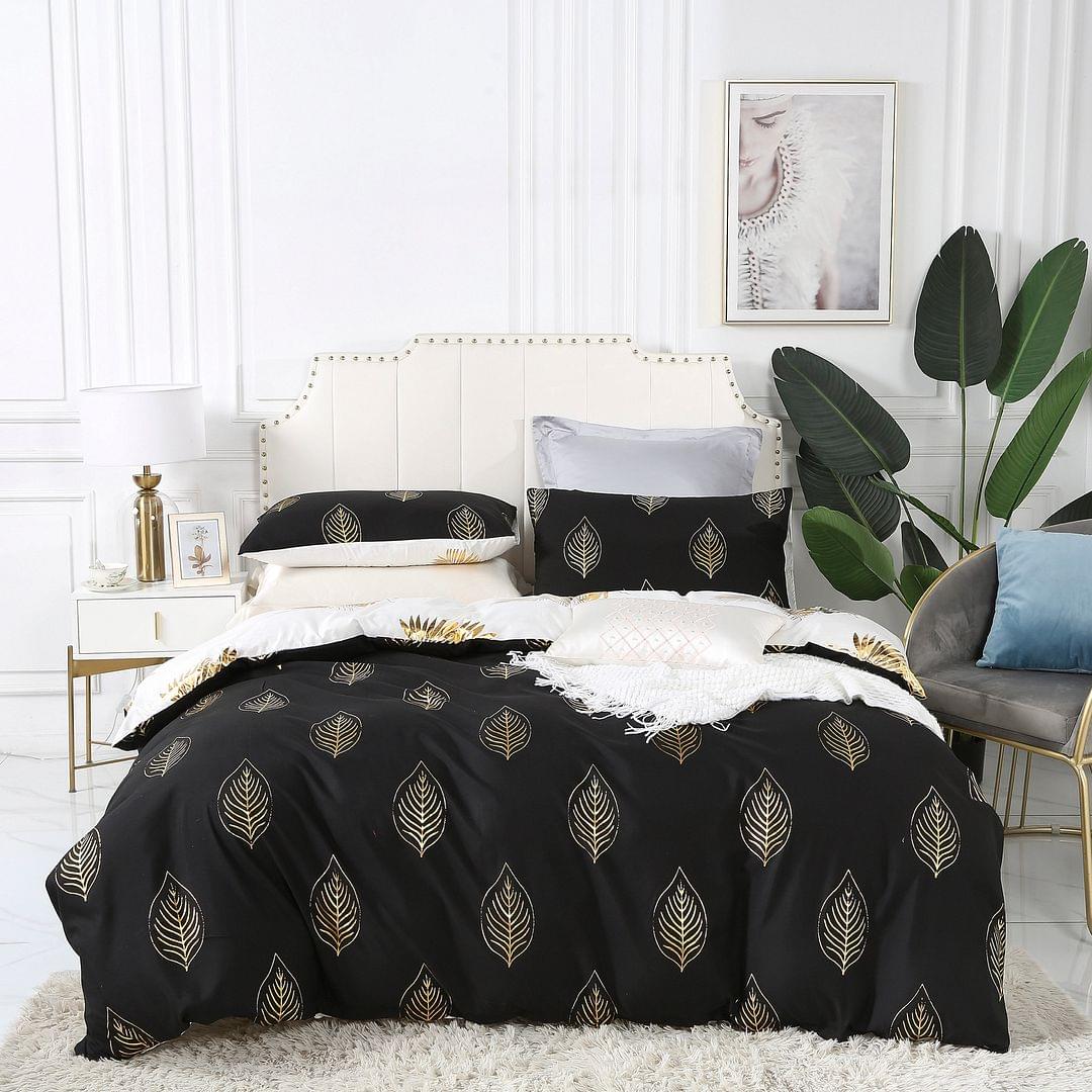Reversible queen bed quilt set, black fabric with gold outlined leaf print