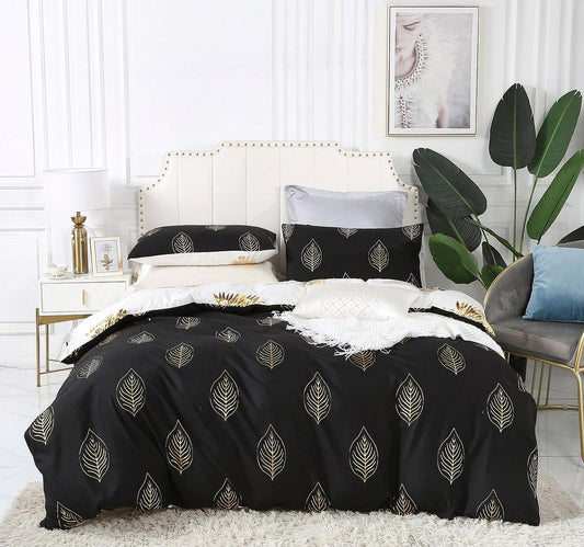Reversible duvet quilt cover set with pillowcases, black and gold leaf pattern