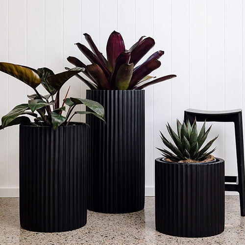 Ribbed plant pot set in dark charcoal with three cylindrical planters