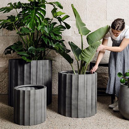 Ribbed planter set, dark grey cylindrical pots with vertical ridges and flat rims