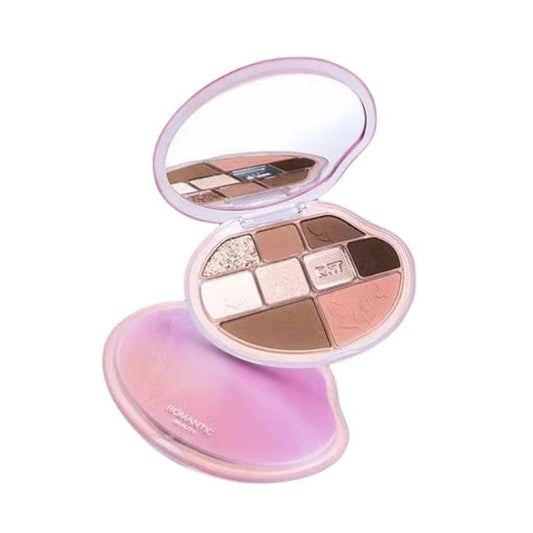 Open flower-shaped eyeshadow palette with nine pans in nude, pink, and brown shades