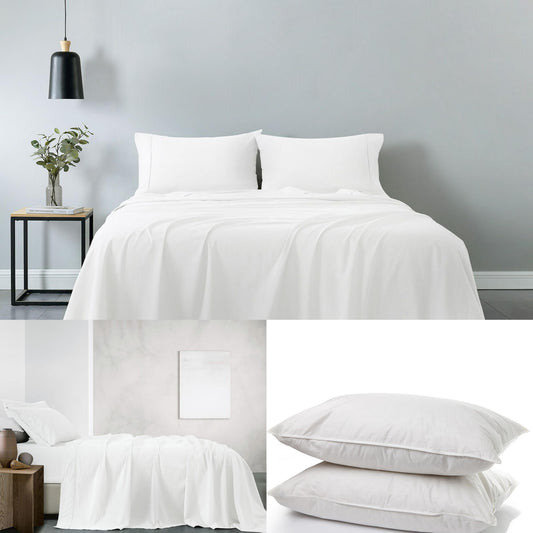 White cotton sheet set with two down pillows on a king bed