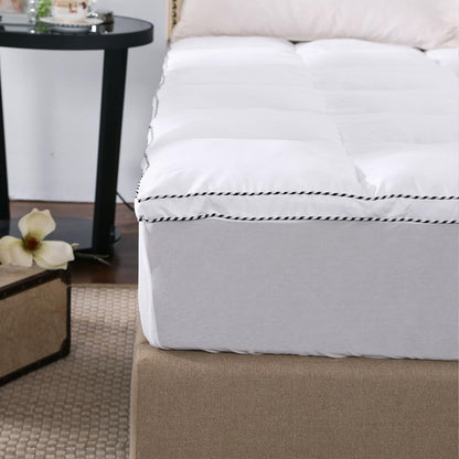 White mattress pad topper cover with fitted skirt and double-stitched edge