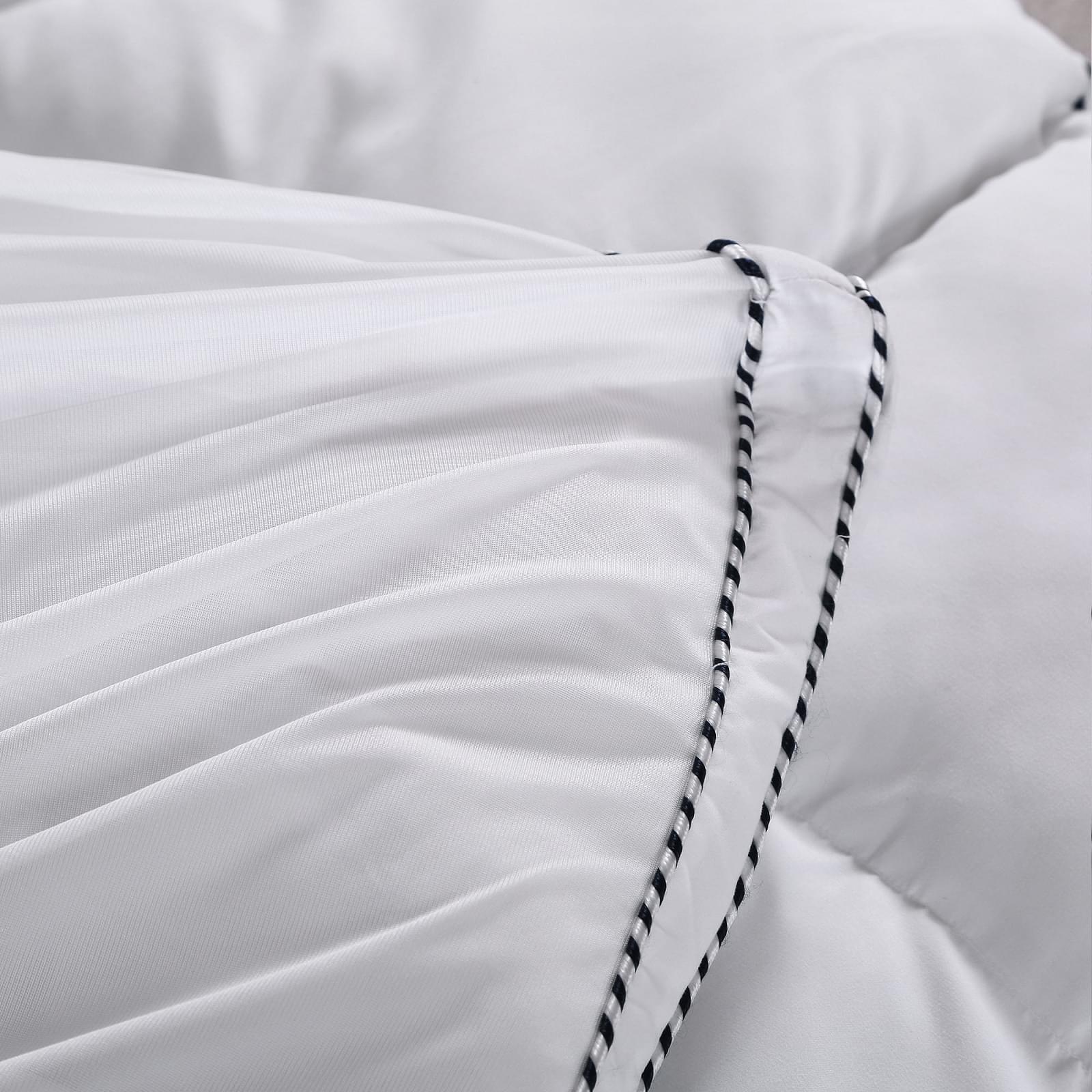 White mattress pad topper cover corner with black-and-white striped piping