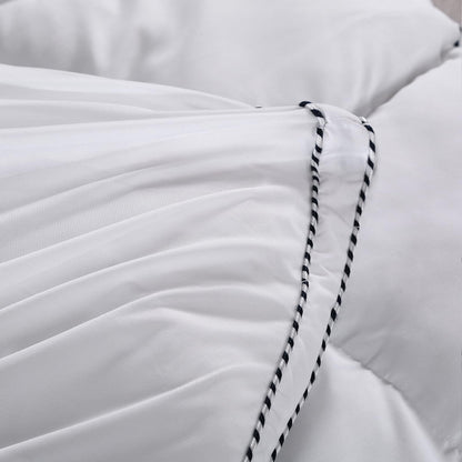 White mattress pad topper cover corner with black-and-white striped piping