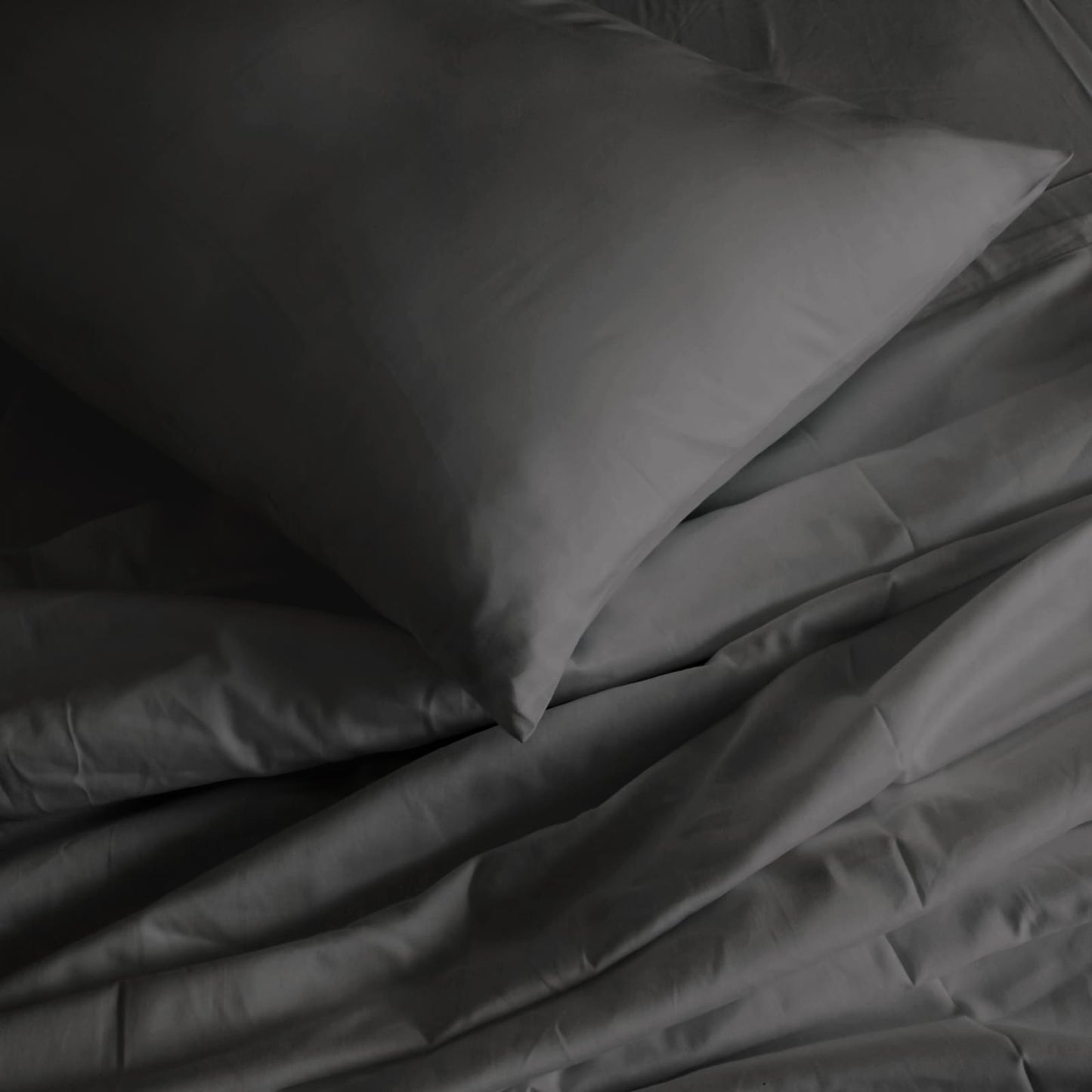 Pewter pillowcase and sheet close-up with folded corner detail