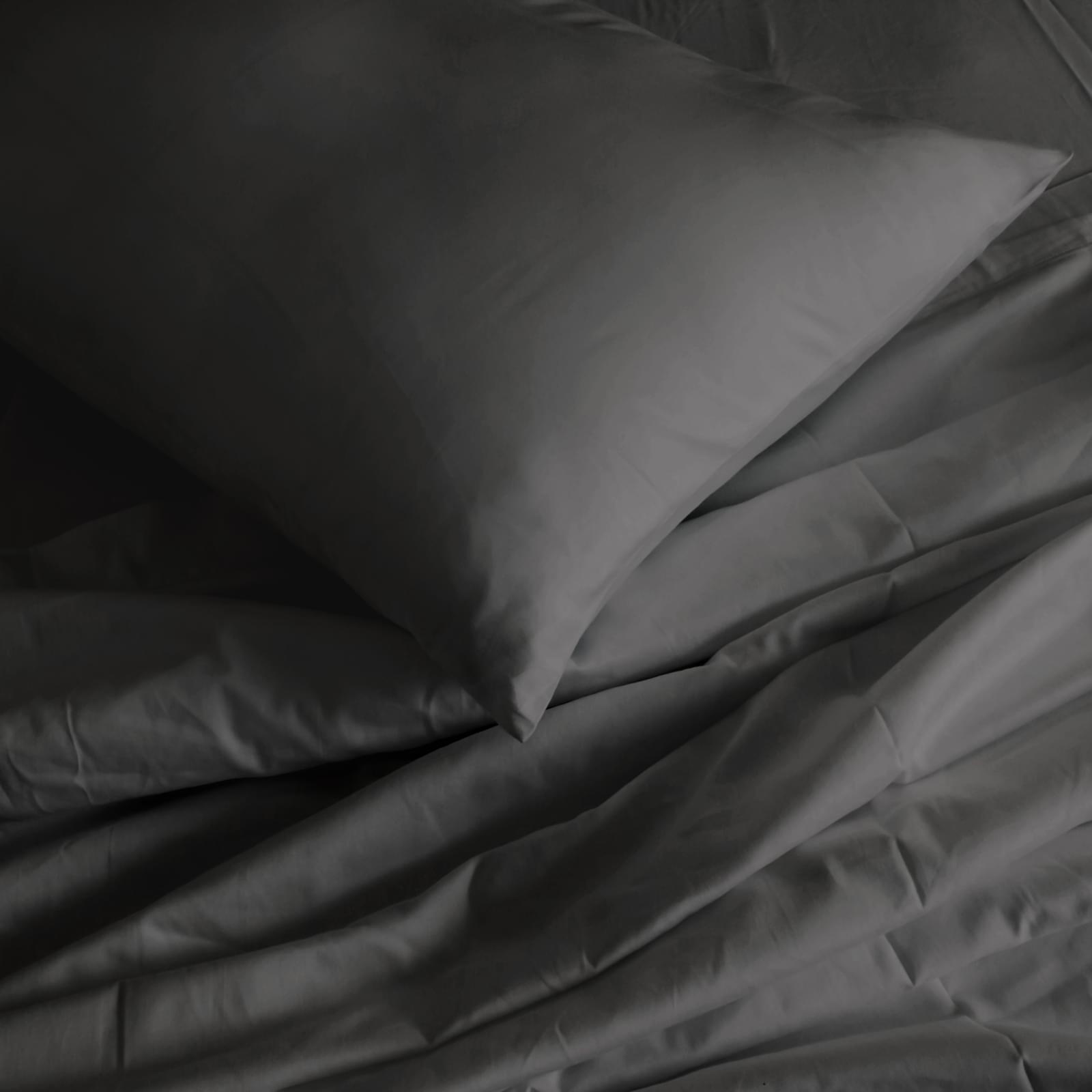 Pewter pillowcase and sheet close-up with folded corner detail