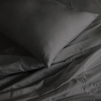Pewter pillowcase and sheet close-up with folded corner detail