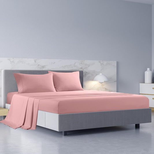 Blush queen sheet set and pillowcases on a bed with matching bedding
