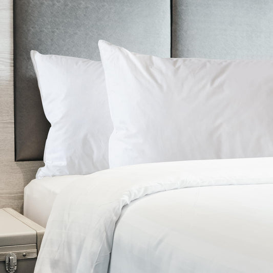 White duck feather down pillows on a bed