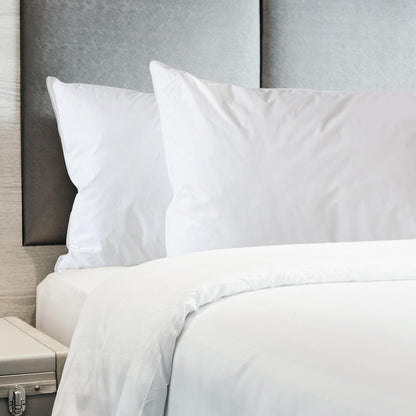 White duck down pillows set, two pillows on a bed edge