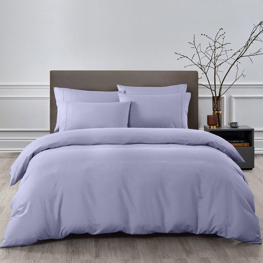 Lilac-grey quilt cover set with matching pillowcases, shown on a king bed