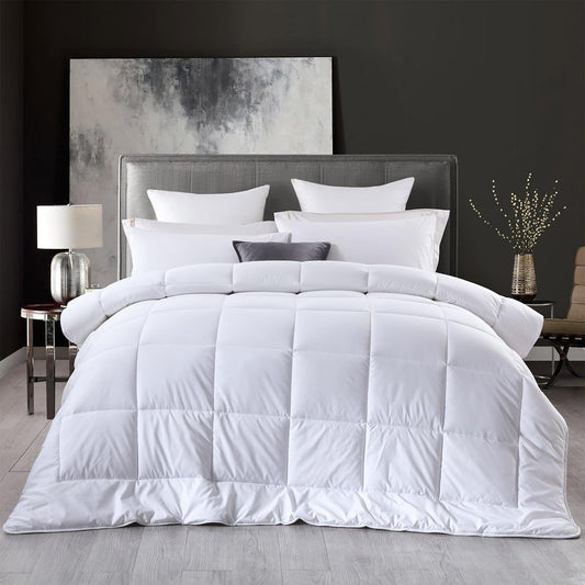 White quilt layered on bed with matching pillows