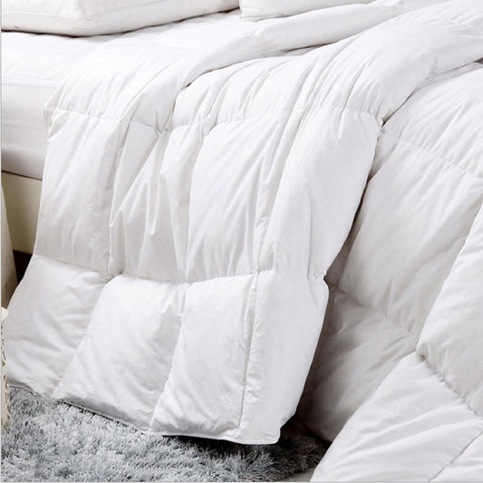 White plush comforter with puffed baffles and box quilting, king bed
