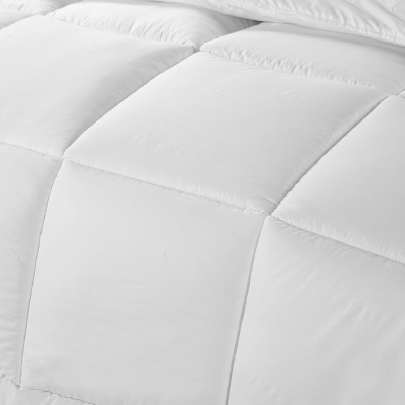 White quilted duvet panels with stitched baffle seams, close-up