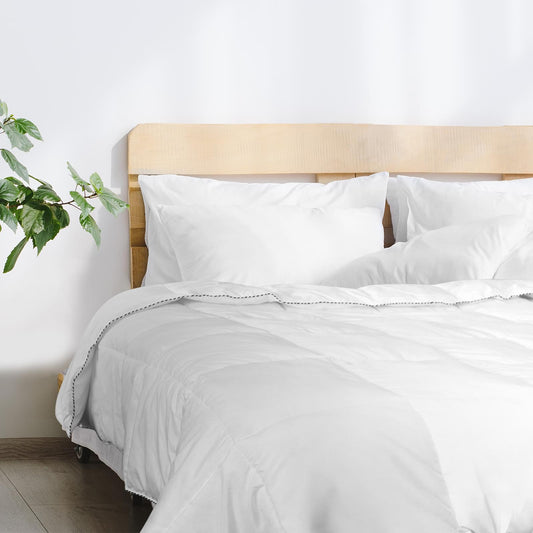 White duvet on bed with pillows, quilted top