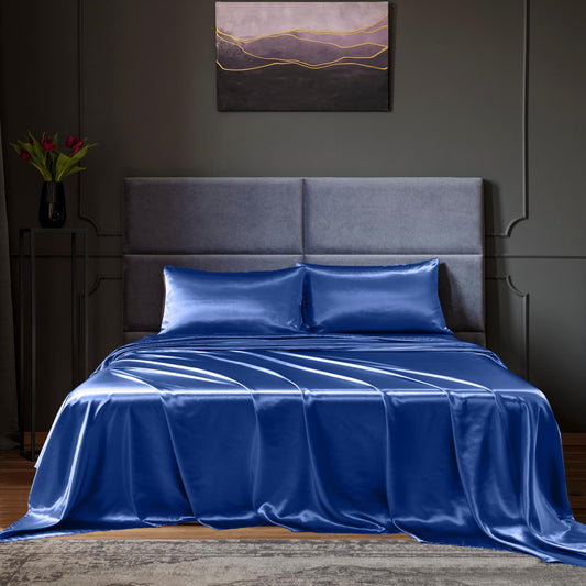 Navy satin sheet set on king bed with pillowcases and flat sheet
