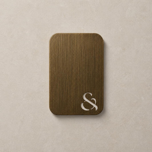 Antique brass color swatch card with decorative ampersand emblem