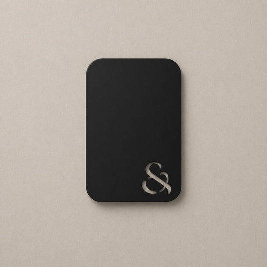 Matt black color swatch with metal S emblem, rounded square