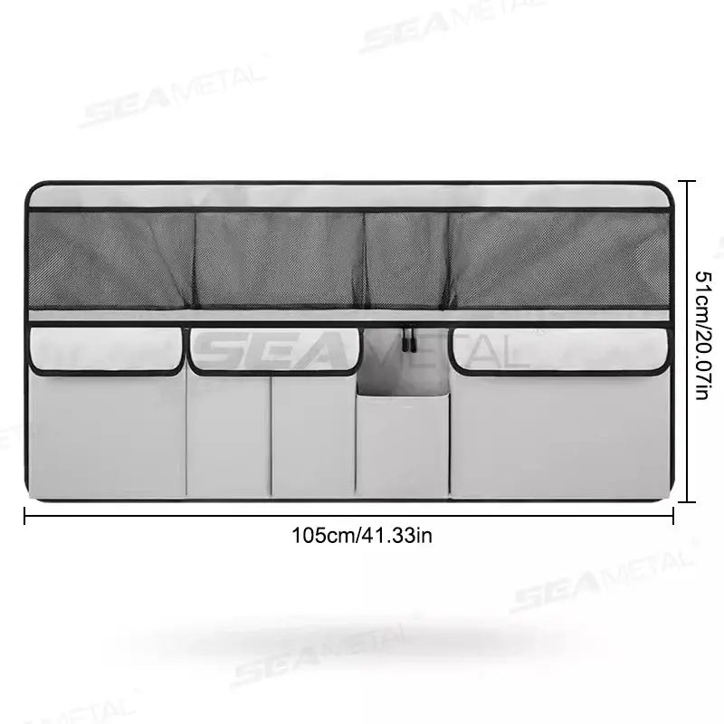 Gray car seat back organizer panel with eight storage sections and upper mesh pocket