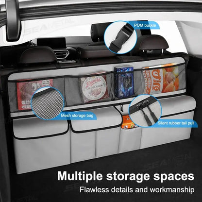Gray car seat back organizer with mesh pocket, rubber pull tab, and divided storage bins