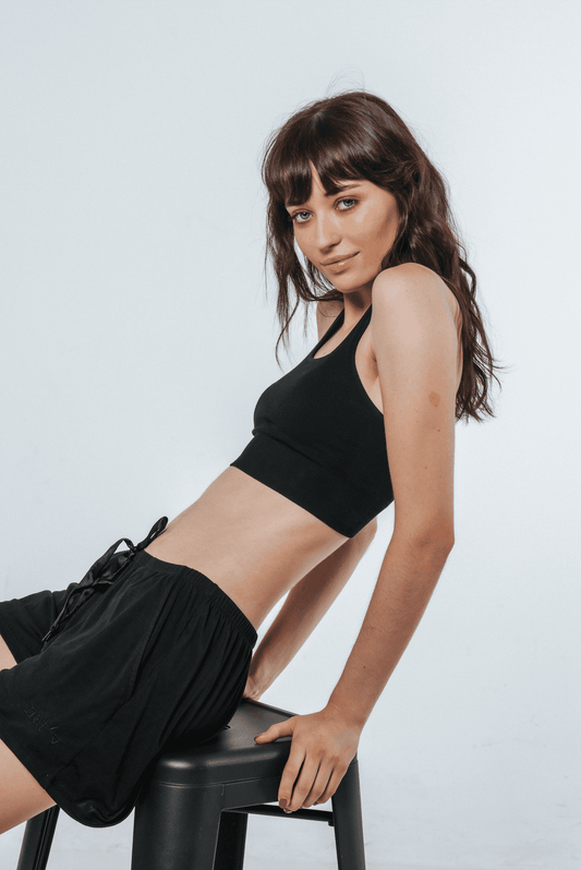 Black racerback crop top with wide straps and scoop neckline