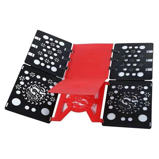 Clothes folding board with black patterned panels and red central insert