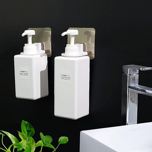 Set of two self-adhesive shower gel bottle holders with white pump dispensers