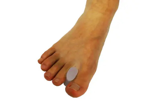 Silicone toe spacer on big toe, white separator pad under forefoot