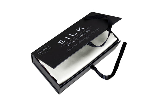 Silk pillowcase in gift box with satin folds and black ribbon