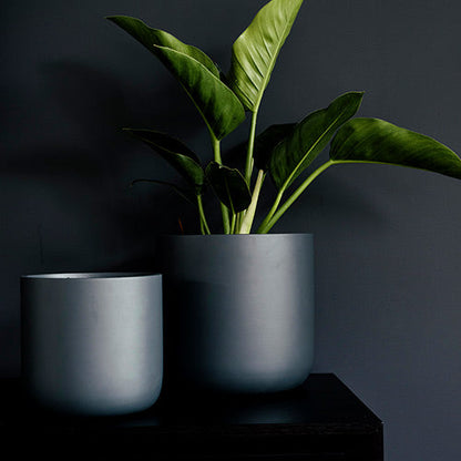 Dark gray round planter set with two pots and leafy green stems