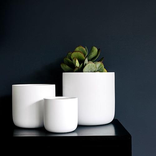 White planter set with three round pots, including a small center pot