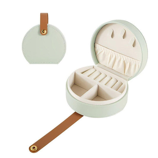 Portable round jewelry box, open with ring and necklace compartments