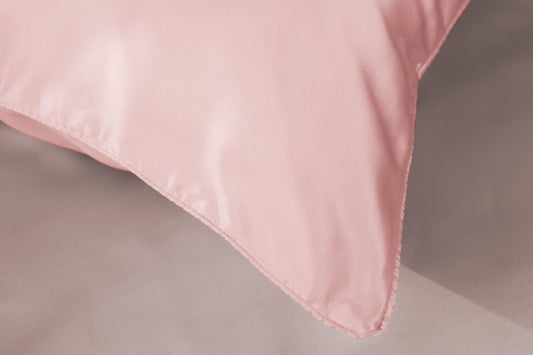 Soft pink silk pillowcase corner with neat seam detail