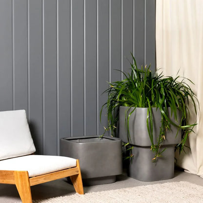 Concrete gray stacked cube planters set with long grass plant