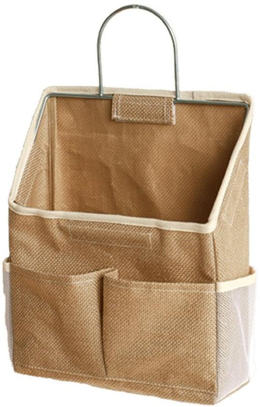 Wall-mounted storage bag with two front pockets and fabric handle, tan color.