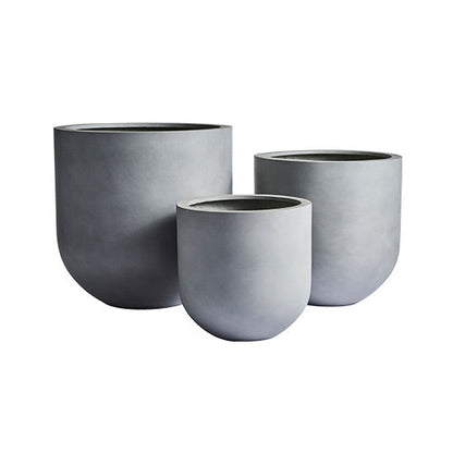 Three matte gray round planter pots of different sizes, no plants shown.