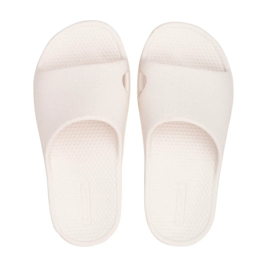 White orthotic slide sandals with contoured footbed and textured outsole