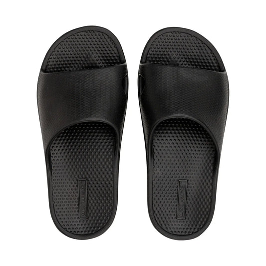 Black orthotic slide sandals with textured footbed and open toe strap.