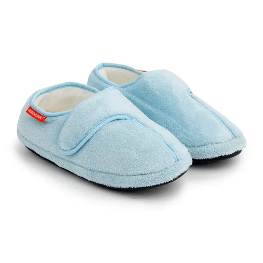Baby blue plush slip-on orthotic slippers with Velcro strap and cushioned footbed