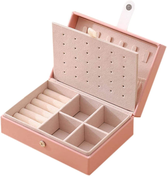 Pink PU leather jewelry storage box with hinged lid, ring slots, and divided compartments.