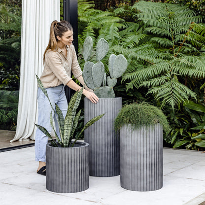 Charcoal grey ribbed planters, three cylindrical pots with vertical fluted texture