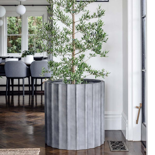 Ribbed planter pot, light concrete grey cylindrical shape with vertical ridges