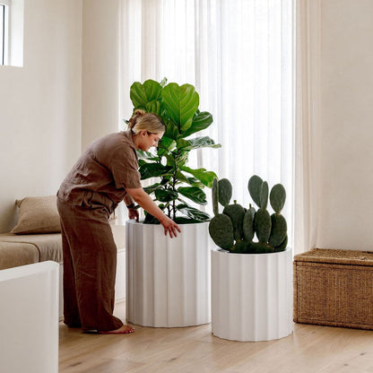 Ribbed planter pot, white cylindrical shape with vertical ridges and wide top opening