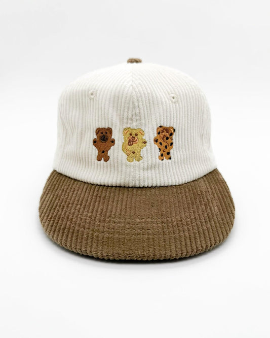 Two-tone knit bear hat with white crown, brown brim, and three bear patches